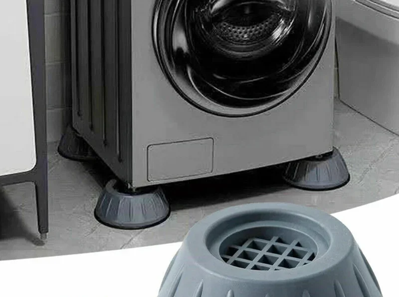 Washing machine vibration pads installed under front load washing machine on tile floor in Pakistani home