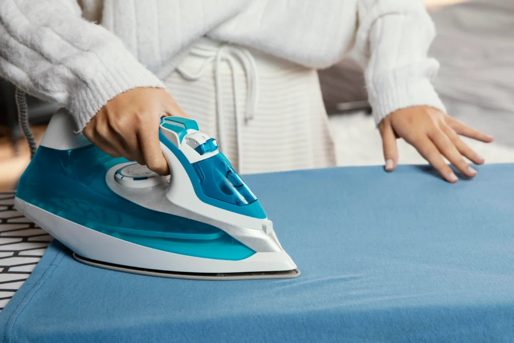 Electric iron price Pakistan 2026 – top brand irons including National, Philips and Anex displayed on ironing board